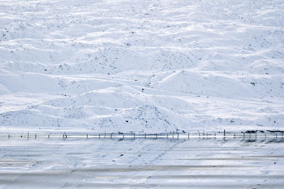 Scenic view of lake by snowcapped mountains