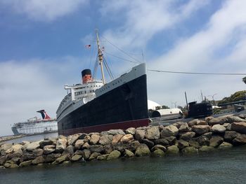 Ship at harbor against sky