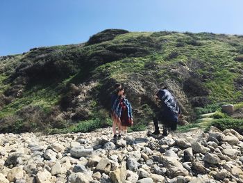 Rear view of man standing on rock formation