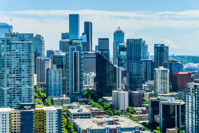 Tall buildings in downtown seattle, washington with mount rainier in the distance