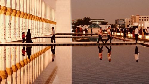 People walking on footpath in city