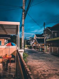 View of railroad tracks by buildings in city against sky