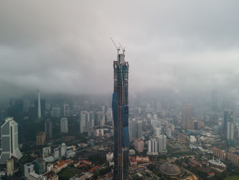 High angle view of modern buildings in city against sky