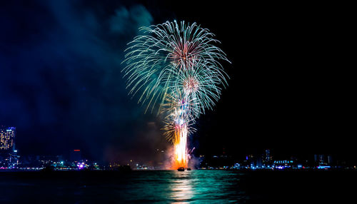 Firework display over city at night