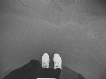 Low section of woman standing in water