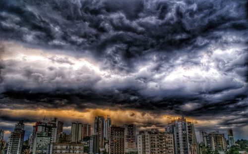 City skyline against cloudy sky