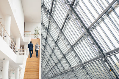 Business partners walking on staircase in office