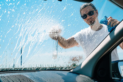 Man washing car windshield