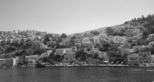 City by sea against clear sky