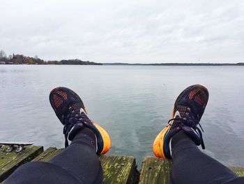 Low section of woman standing in lake