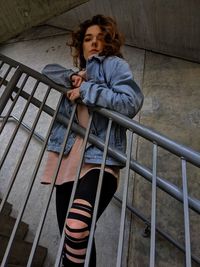 High angle view of woman looking down on railing