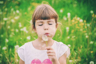 Close-up of girl blowing bubbles