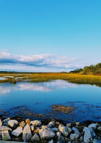 Scenic view of lake against blue sky