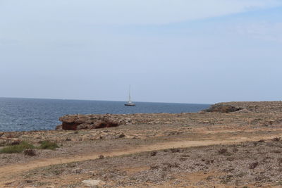 Sailboat sailing on sea against sky