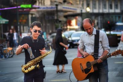 Men playing music on city street