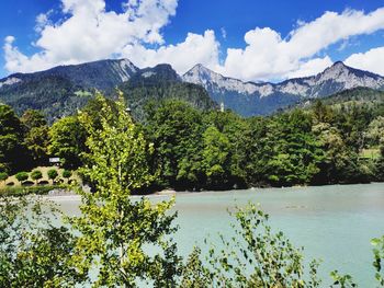 Scenic view of lake and mountains against sky