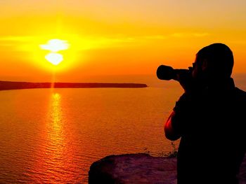 Silhouette of people at sunset