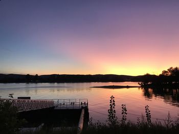 Scenic view of lake against romantic sky at sunset