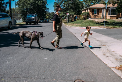 People with dog on street in city