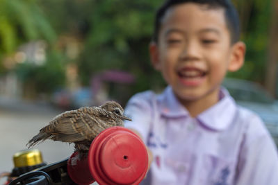 Portrait of boy holding outdoors