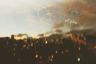 Close-up of illuminated lights against sky at night