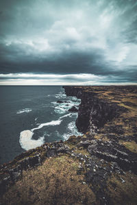 Scenic view of sea against storm clouds