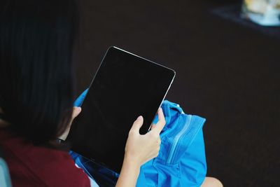 High angle view of woman using digital tablet