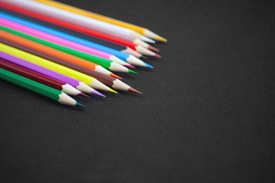 Close-up of multi colored pencils on table
