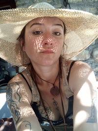 Portrait of young woman in hat