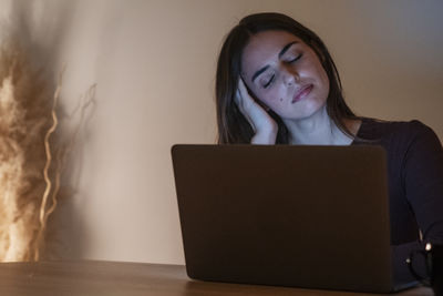 Young woman using laptop at home