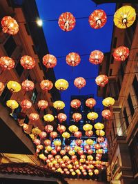 Low angle view of illuminated lanterns hanging at night