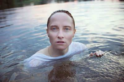 Portrait of woman swimming in lake