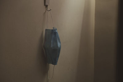 Close-up of clothes hanging on wall at home
