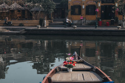 Boats in canal along buildings