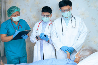 Doctors examining patient at hospital