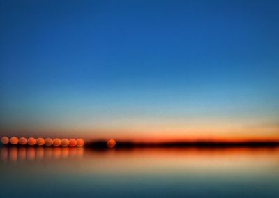 Scenic view of sea against clear sky at sunset