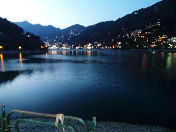 Scenic view of lake against sky at night