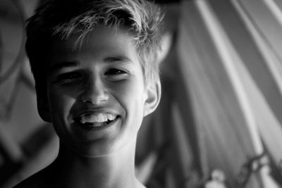 Close-up portrait of smiling boy at home