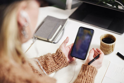 Woman's hands holding cell phone