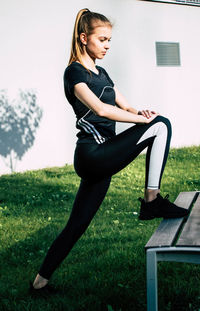 Side view of woman wearing sunglasses on field