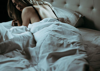 Close-up of man relaxing on bed