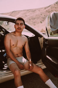 Portrait of young woman in car