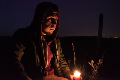 Portrait of young woman at night