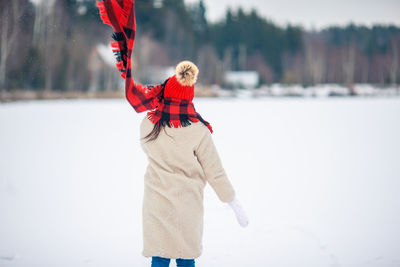 Full length of person standing on snow covered field