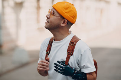 Side view of young man using mobile phone