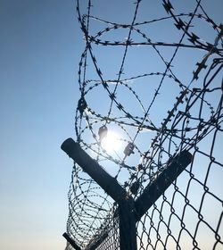 Low angle view of barbed wire against clear sky