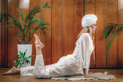 Woman practicing kundalini yoga, kriya exercises for the navel center and bowel waste elimination