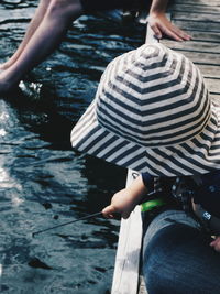 High angle view of child fishing in lake