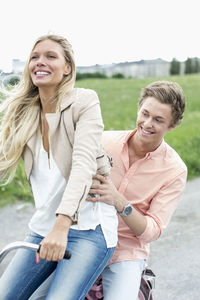 Happy young couple on bicycle at countryside