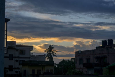 Buildings against sky at sunset